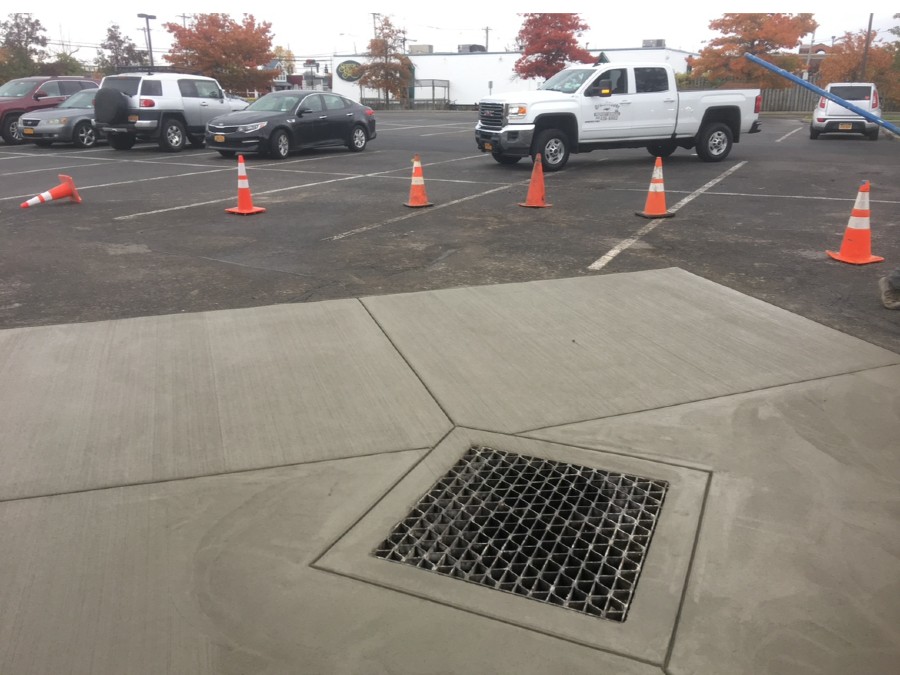 drainage contractors near syracuse ny parking lot drain repair project installed by grasshopper concrete services