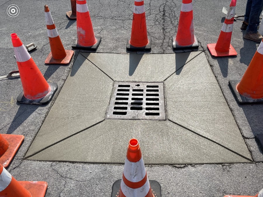 drainage contractors near syracuse ny storm drain repair project surrounded by safety cones
